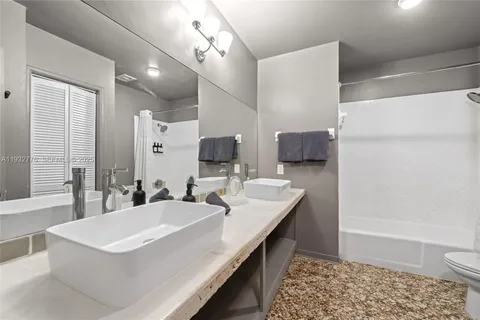 a bathroom with a sink a toilet a mirror and vanity