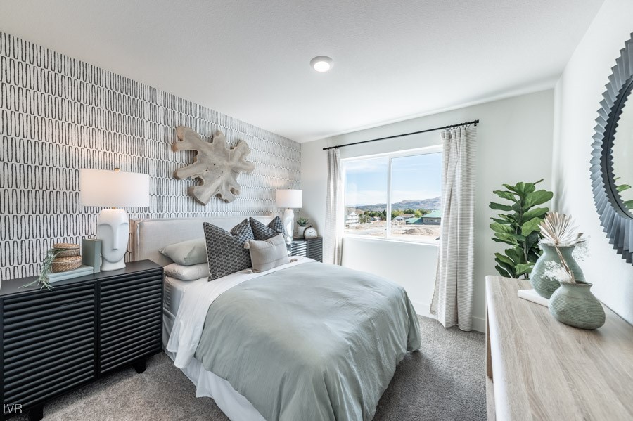 5882 Grand Row Way Reno, NV 89523 - Photo 14 of 19 a bedroom with a bed and a potted plant