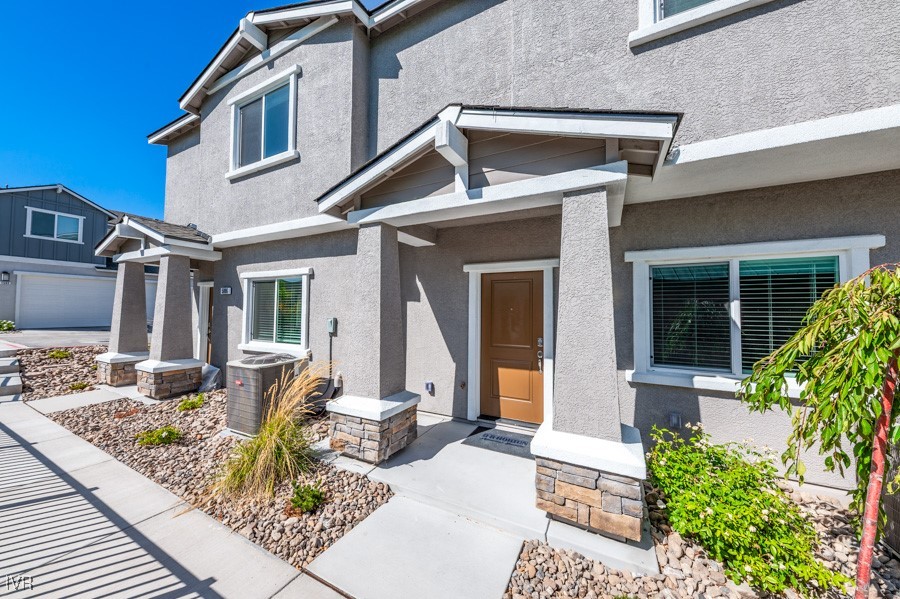 5882 Grand Row Way Reno, NV 89523 - Photo 2 of 19 a front view of a house with garden