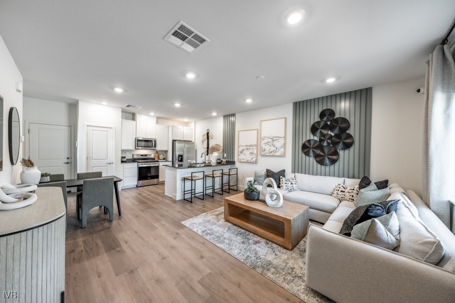 5882 Grand Row Way Reno, NV 89523 - Photo 3 of 19 a living room with furniture kitchen view and a wooden floor