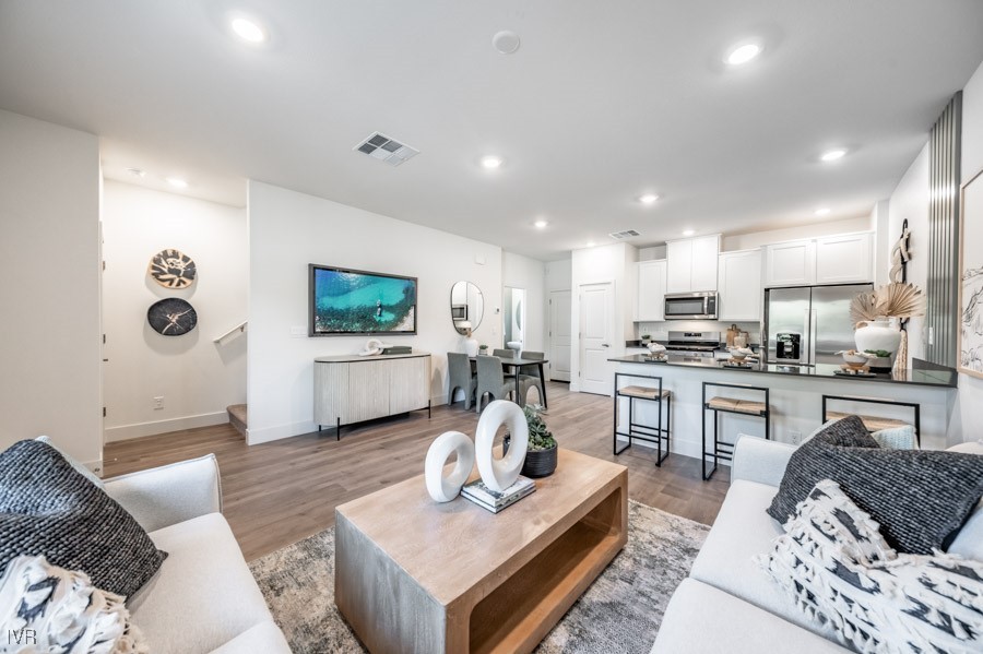 5882 Grand Row Way Reno, NV 89523 - Photo 4 of 19 a living room with furniture kitchen view and a flat screen tv
