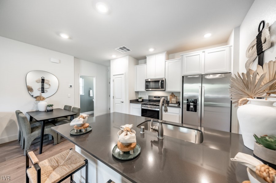 5882 Grand Row Way Reno, NV 89523 - Photo 5 of 19 a kitchen with stainless steel appliances granite countertop a sink a stove and refrigerator