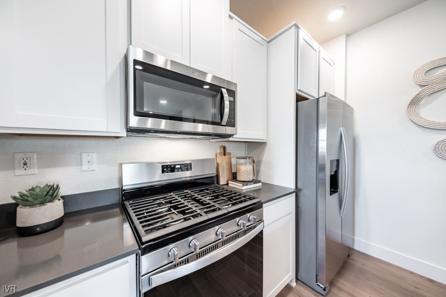 5882 Grand Row Way Reno, NV 89523 - Photo 7 of 19 a kitchen with stainless steel appliances granite countertop a refrigerator and a stove top oven