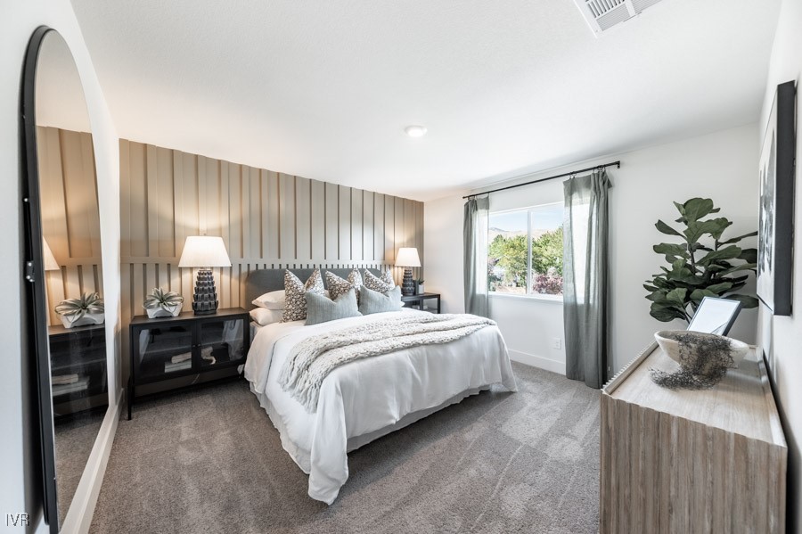 5882 Grand Row Way Reno, NV 89523 - Photo 8 of 19 a bedroom with a bed table flowerpot and window