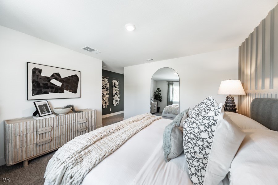 5882 Grand Row Way Reno, NV 89523 - Photo 9 of 19 a bedroom with a bed and a flat screen tv