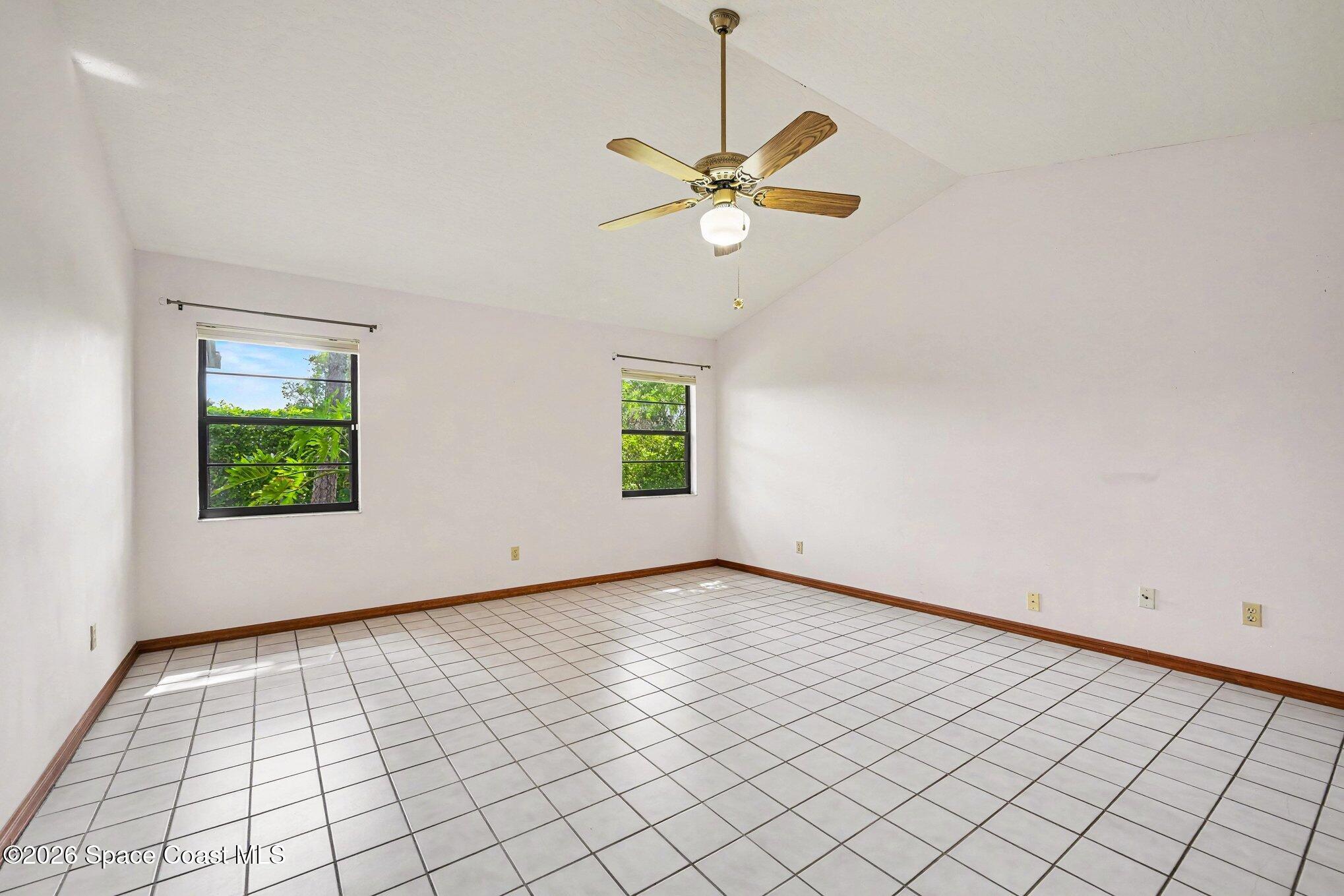 899 Ridge Lake Drive Melbourne, FL 32940 - Photo 13 of 34 an empty room with windows and fan