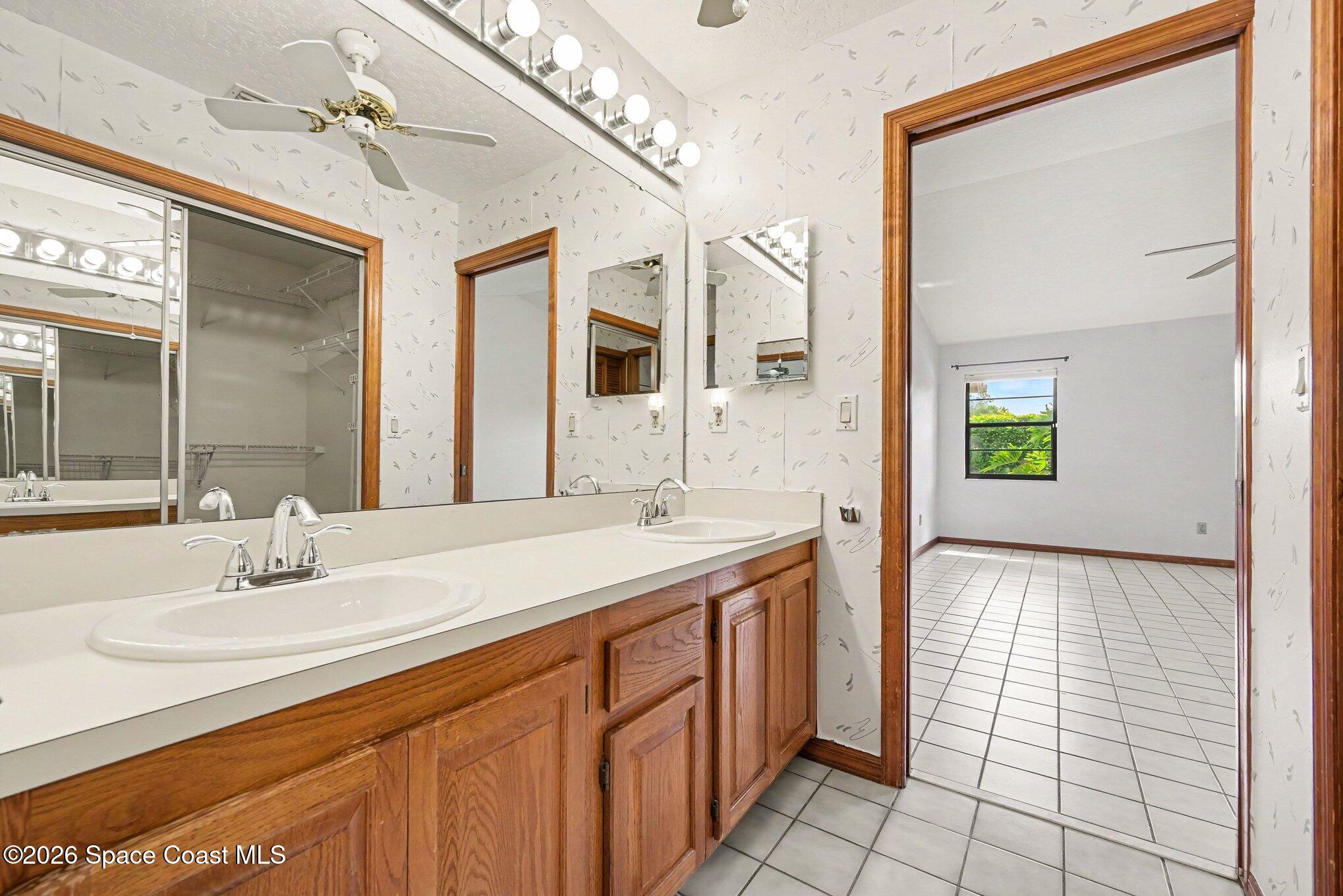 899 Ridge Lake Drive Melbourne, FL 32940 - Photo 14 of 34 a bathroom with a sink and a mirror