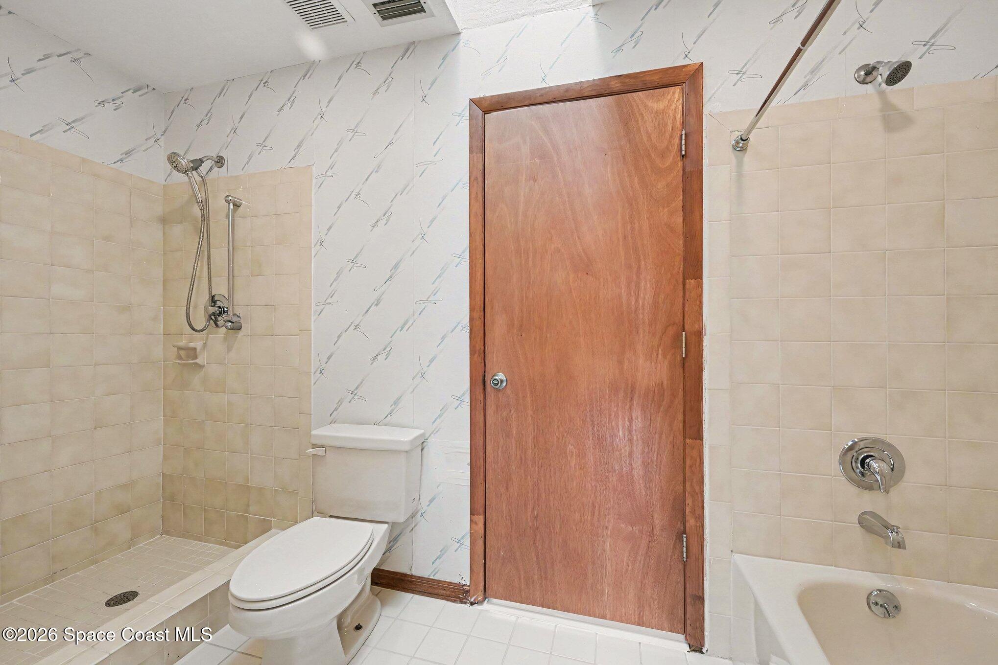 899 Ridge Lake Drive Melbourne, FL 32940 - Photo 15 of 34 a bathroom with a shower a toilet and a sink