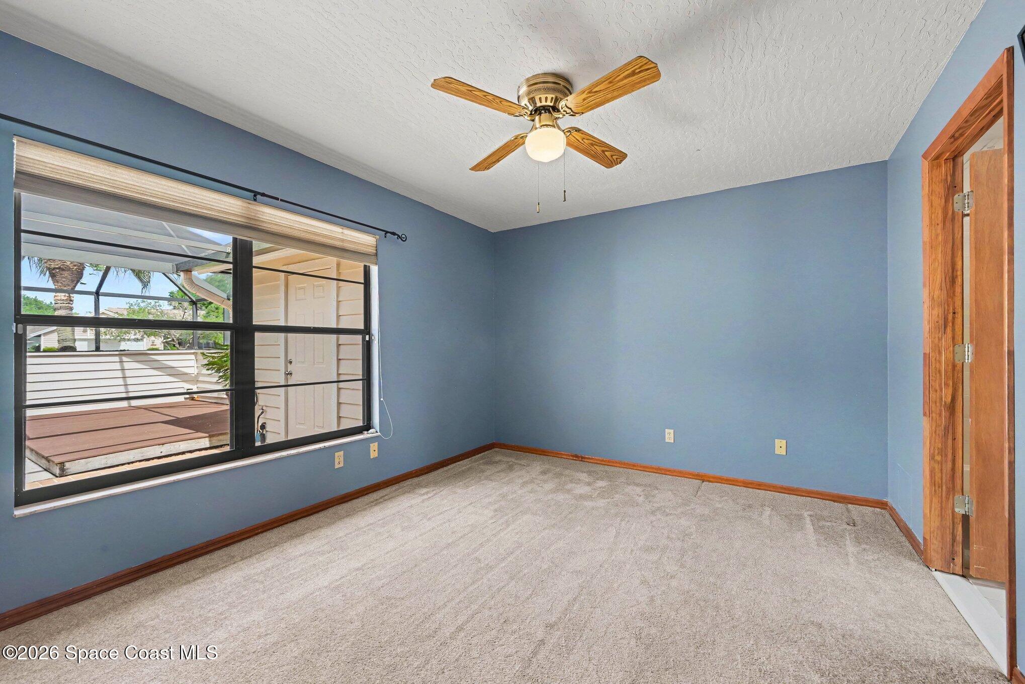 899 Ridge Lake Drive Melbourne, FL 32940 - Photo 17 of 34 an empty room with windows and fan