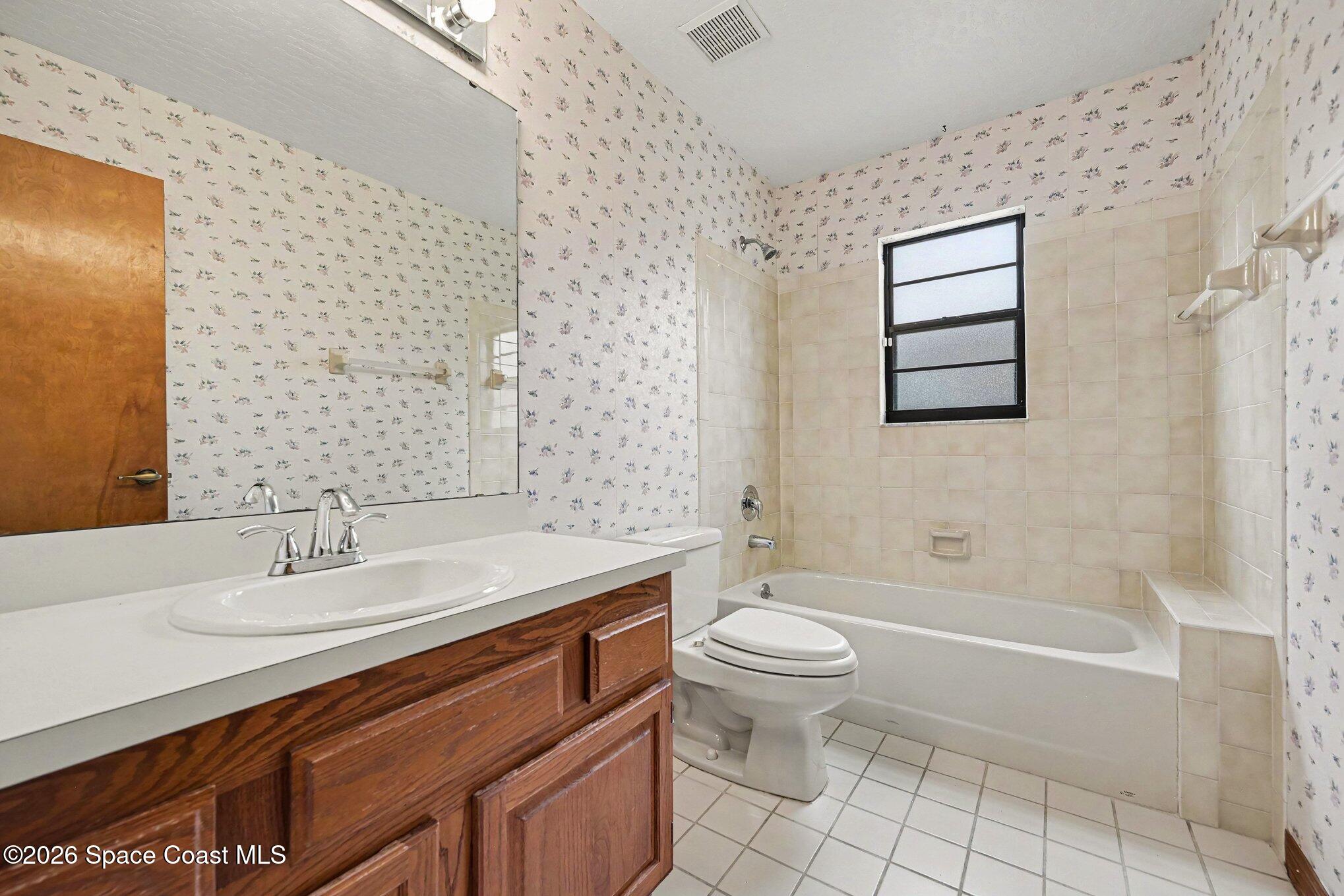 899 Ridge Lake Drive Melbourne, FL 32940 - Photo 19 of 34 a bathroom with a sink toilet and shower