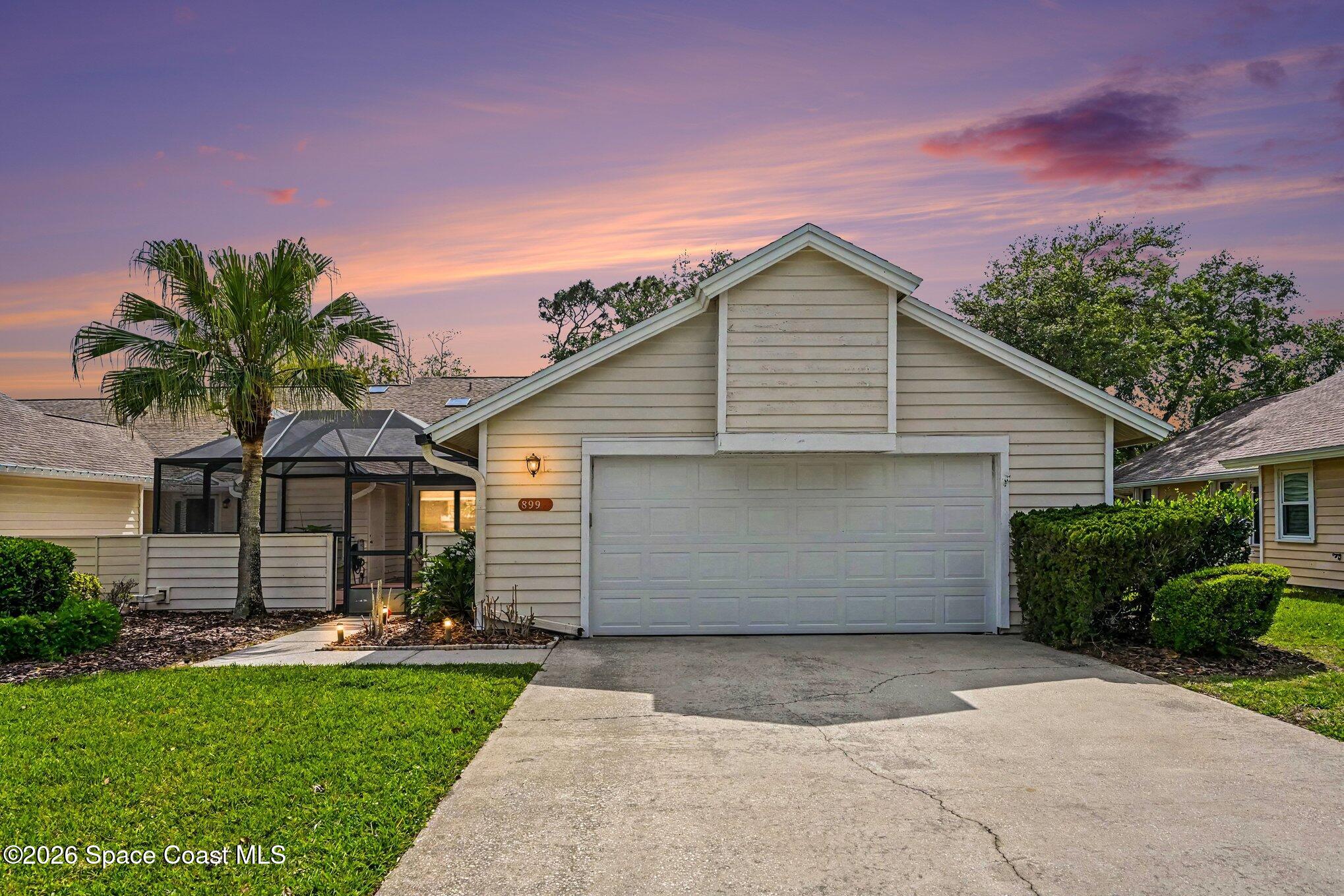 899 Ridge Lake Drive Melbourne, FL 32940 - Photo 2 of 34 a front view of house with yard and trees in the background