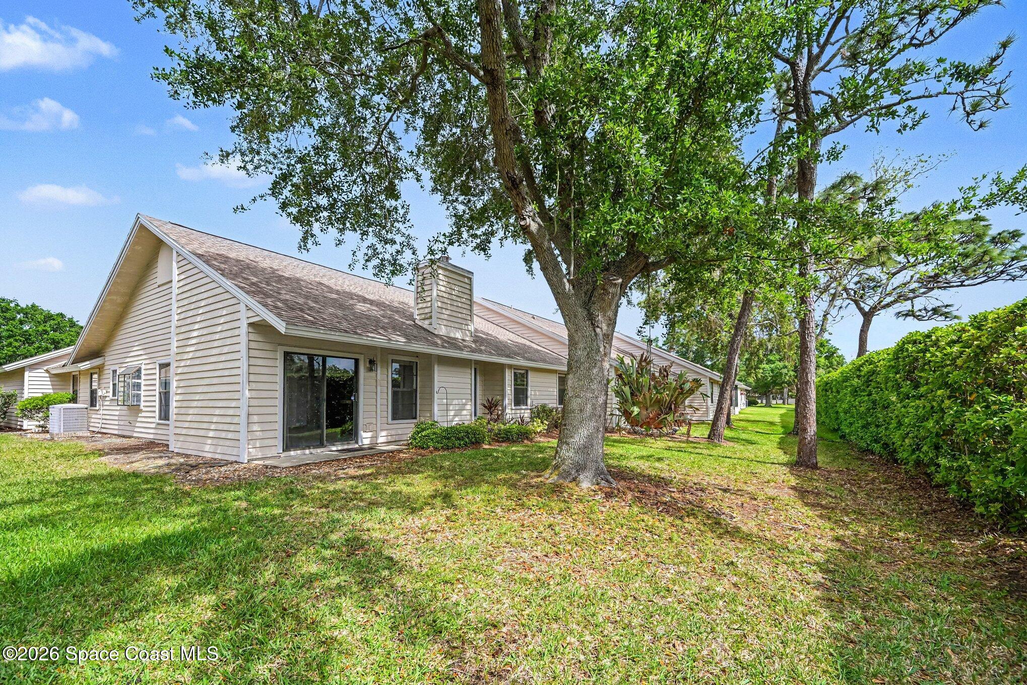 899 Ridge Lake Drive Melbourne, FL 32940 - Photo 25 of 34 a house with trees in the background