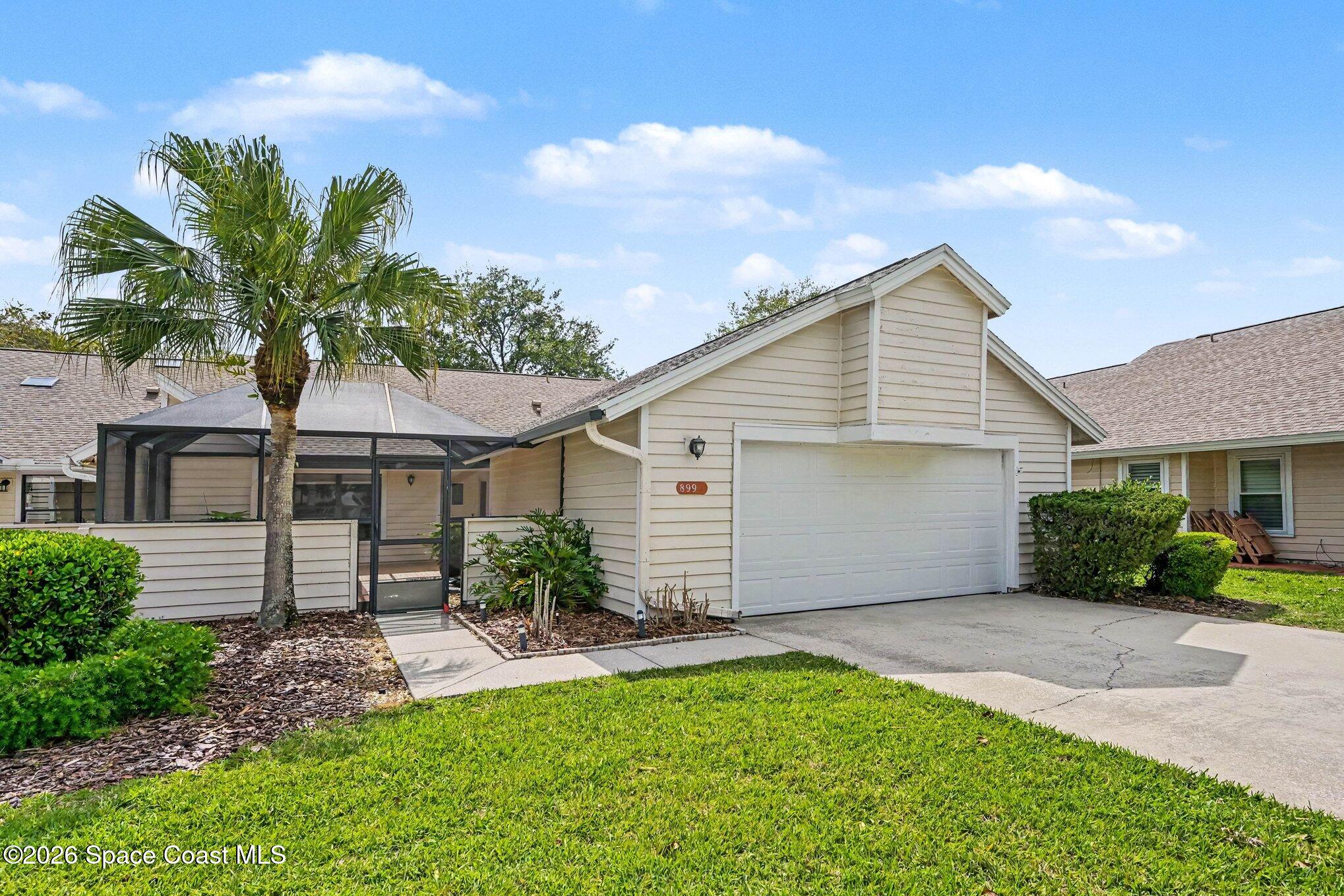 899 Ridge Lake Drive Melbourne, FL 32940 - Photo 3 of 34 a front view of a house with a garden and plants