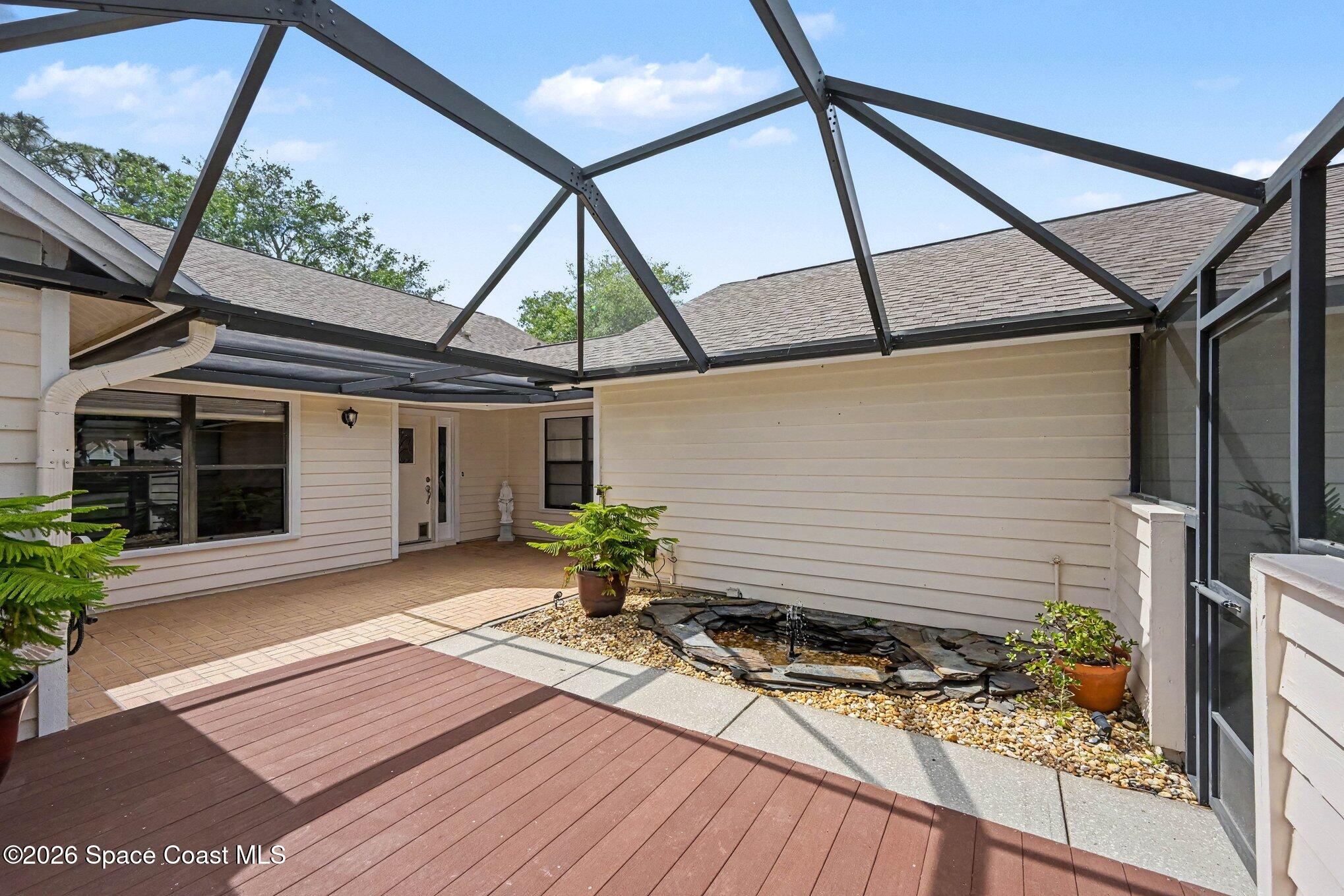899 Ridge Lake Drive Melbourne, FL 32940 - Photo 4 of 34 a front view of a house with garden