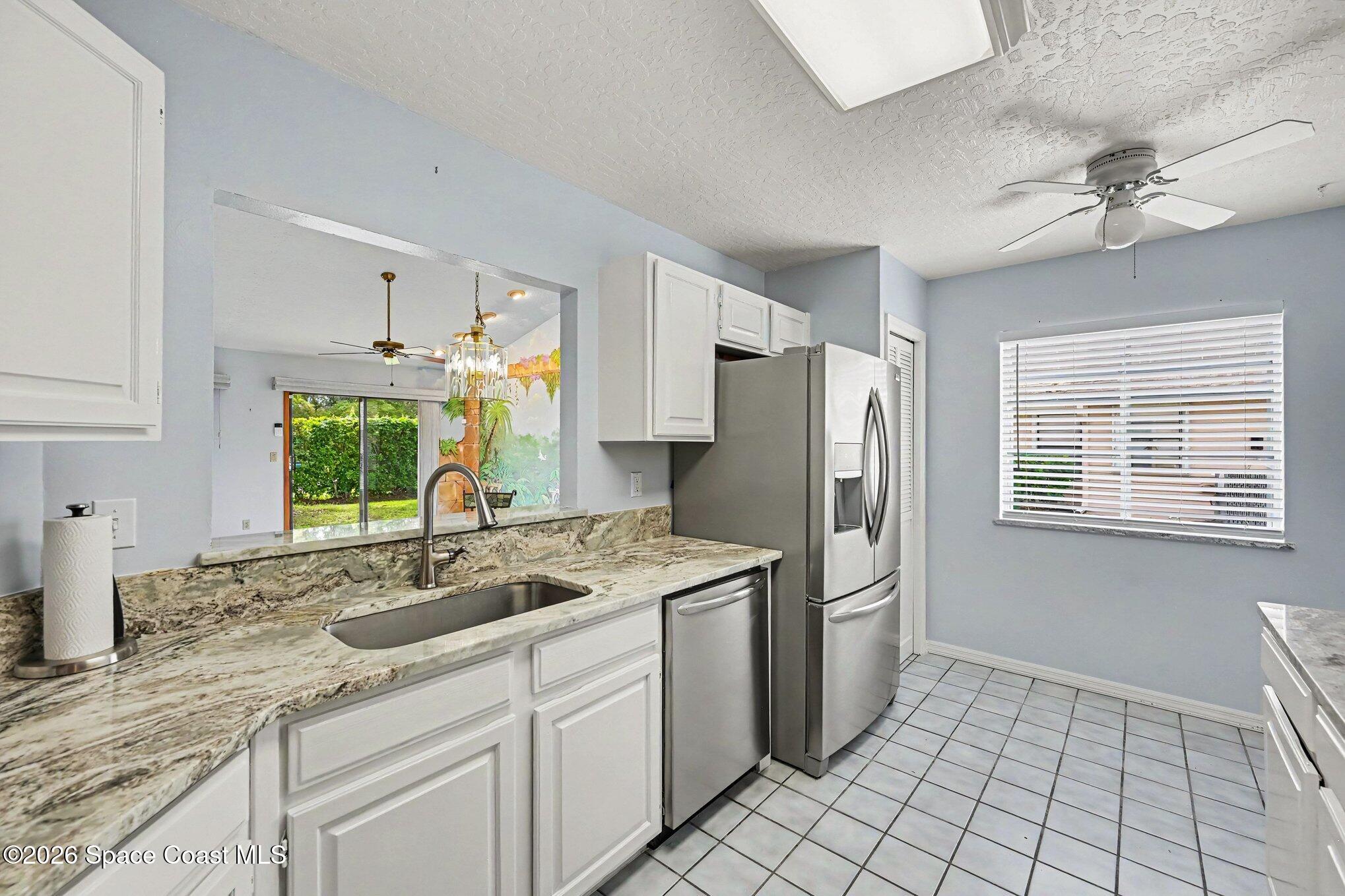 899 Ridge Lake Drive Melbourne, FL 32940 - Photo 10 of 34 a kitchen with a sink stove and refrigerator