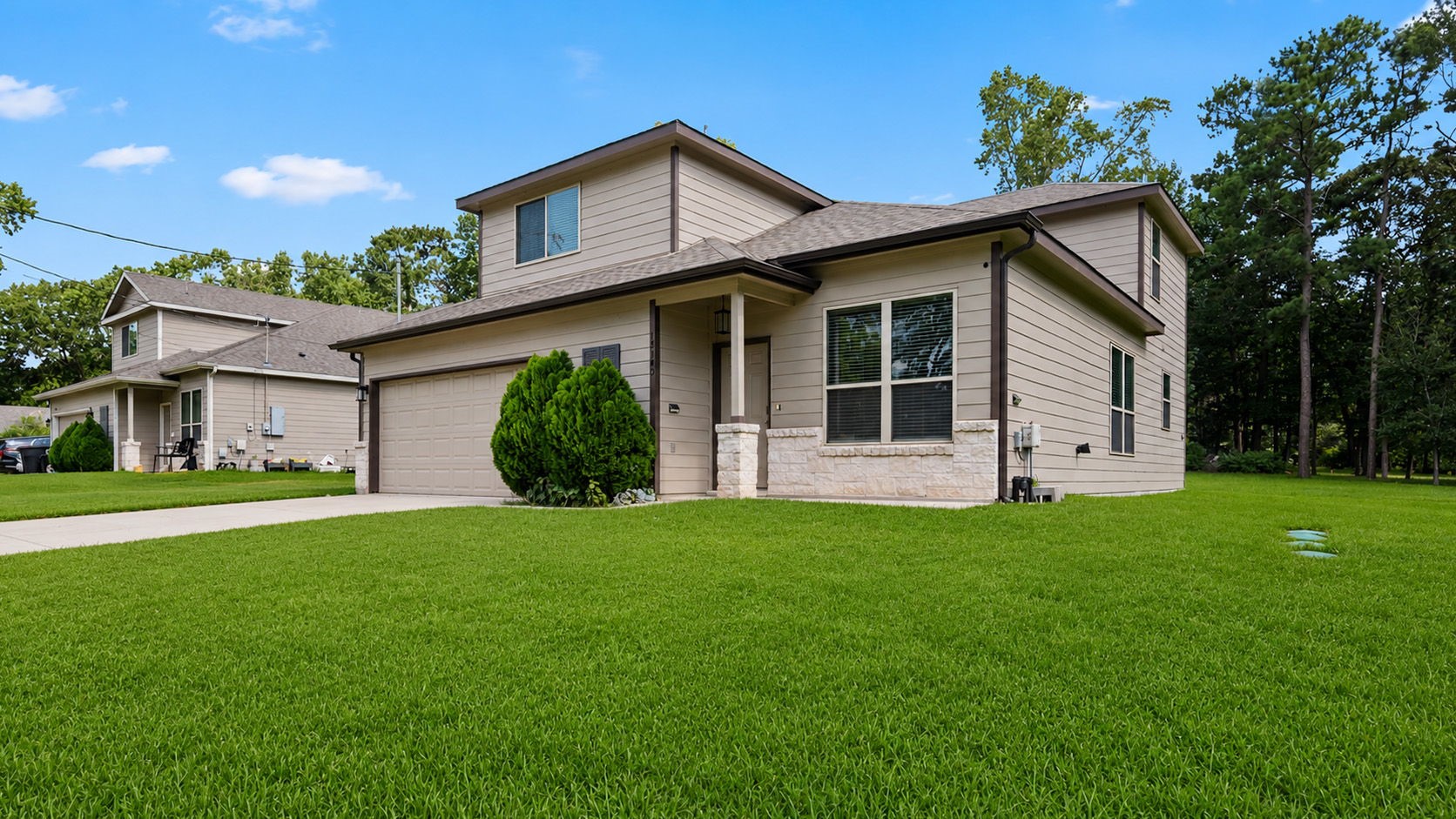 18140 Mail Rte Road Montgomery, TX 77316 - Photo 25 of 26 Beautiful front elevation featuring a covered front porch, two-car garage, and manicured landscaping.