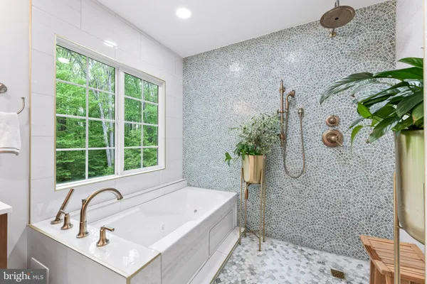 a bathroom with a sink a mirror and a shower