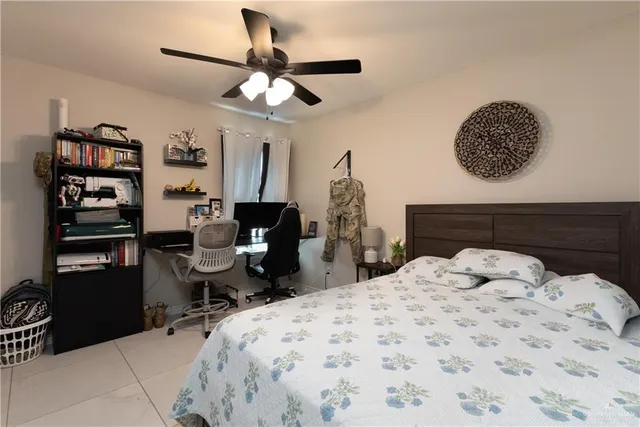 a bedroom with a bed a desk and chair