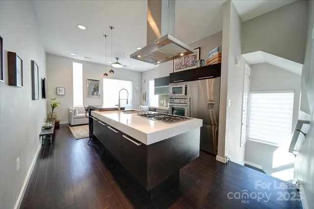 a large white kitchen with a large window
