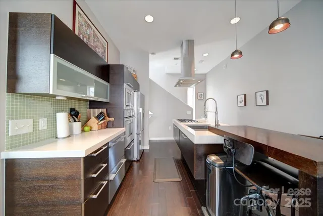 a kitchen with granite countertop a sink appliances and cabinets