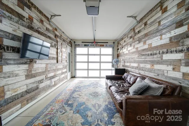 a view of a living room with furniture and a floor to ceiling window