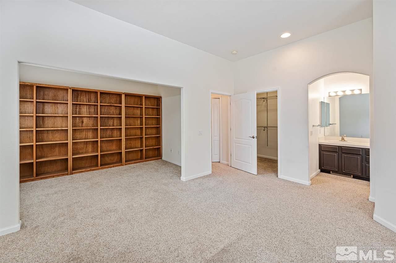 705 Gold Run Court Reno, NV 89521 - Photo 11 of 17 an empty room with a window and a kitchen