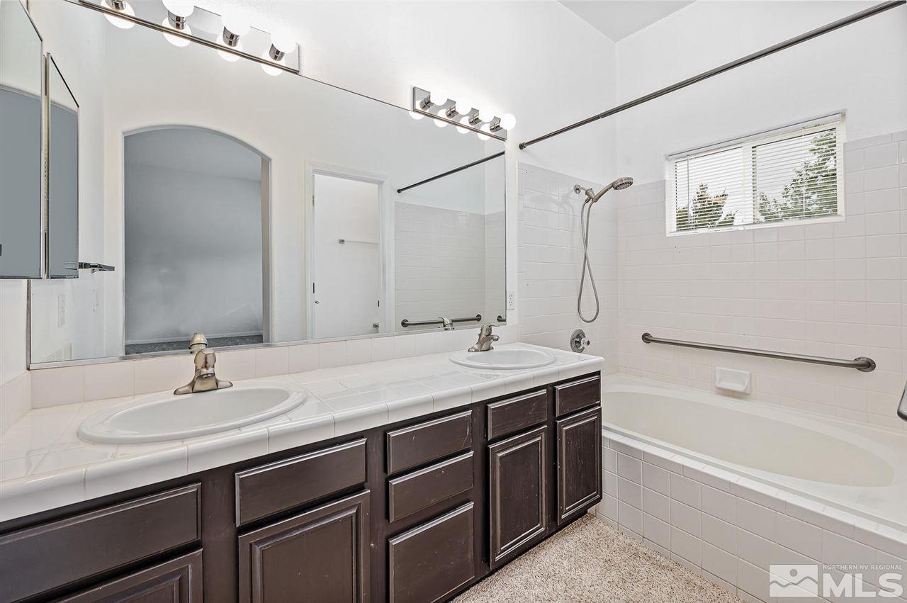 705 Gold Run Court Reno, NV 89521 - Photo 12 of 17 a bathroom with a tub sink and mirror