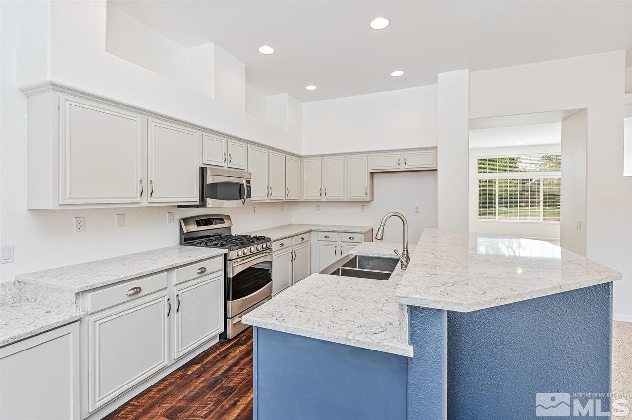 705 Gold Run Court Reno, NV 89521 - Photo 8 of 17 a kitchen with granite countertop white cabinets and white appliances