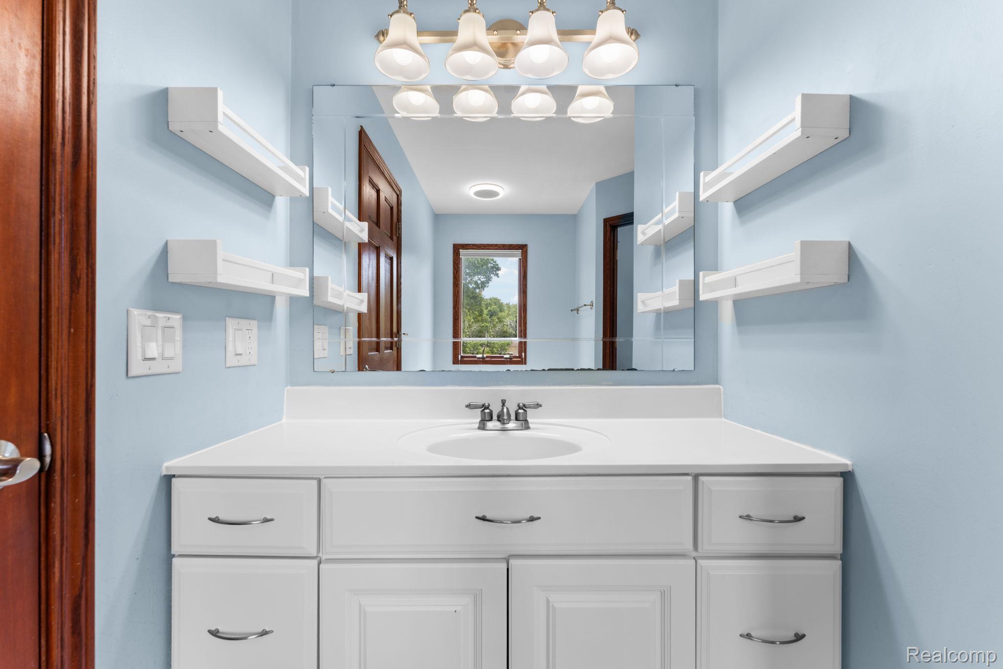 2381 Burke Road Fowlerville, MI 48836 - Photo 17 of 31 White vanity with integrated sink and chrome faucet