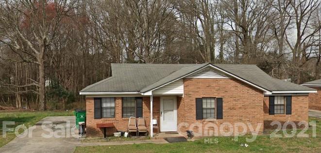 a backyard of a house with barbeque oven