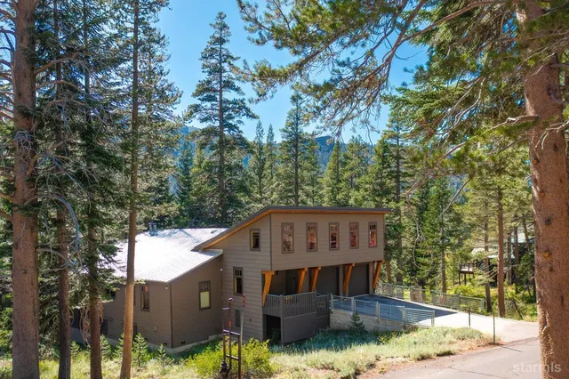 a view of house with yard in front of it