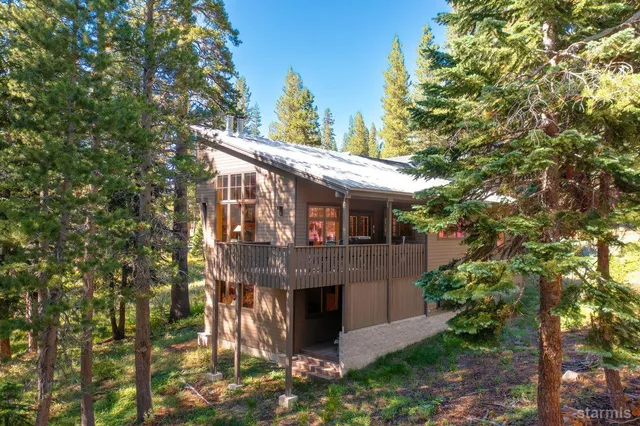 a view of a house with a tree front of house