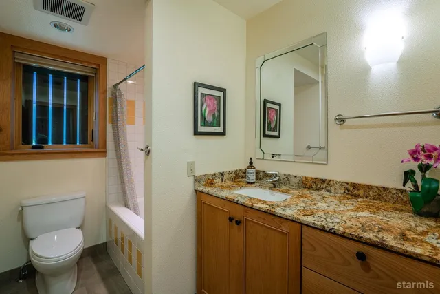 a living room with furniture and large windows