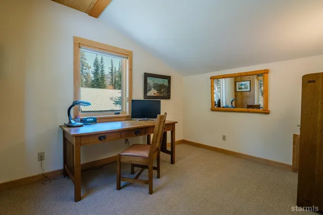 a bedroom with a bed dresser and a window