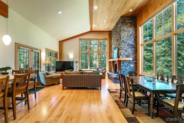 a dining room with furniture window and wooden floor