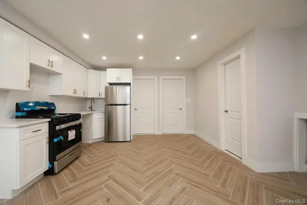 a kitchen with stainless steel appliances granite countertop a refrigerator and a stove top oven
