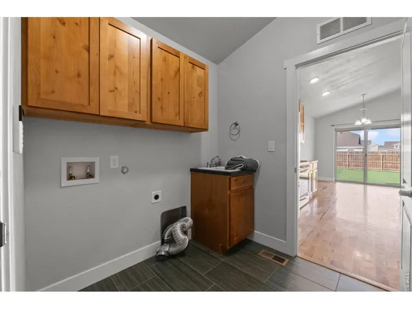 a kitchen with stainless steel appliances granite countertop a sink and a refrigerator