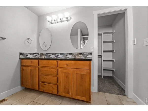 a view of an empty room with a ceiling fan and a window