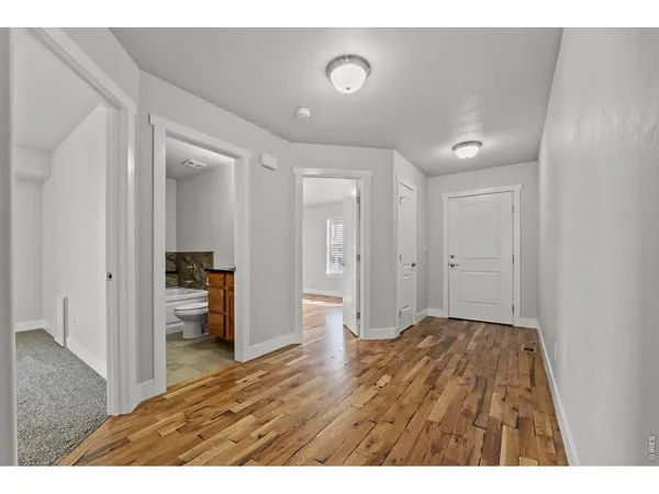 a view of empty room with wooden floor