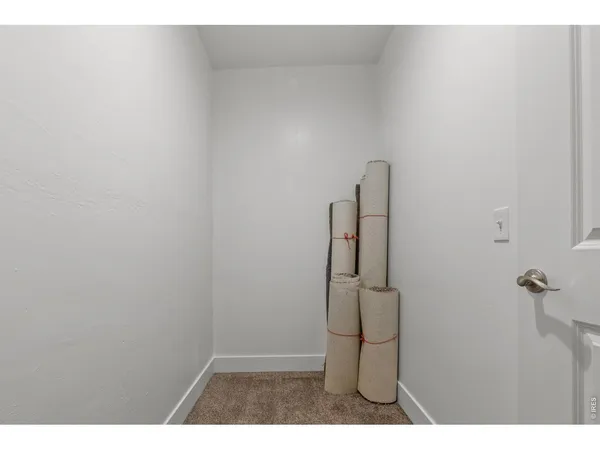 view of a room with wooden floor and mirror