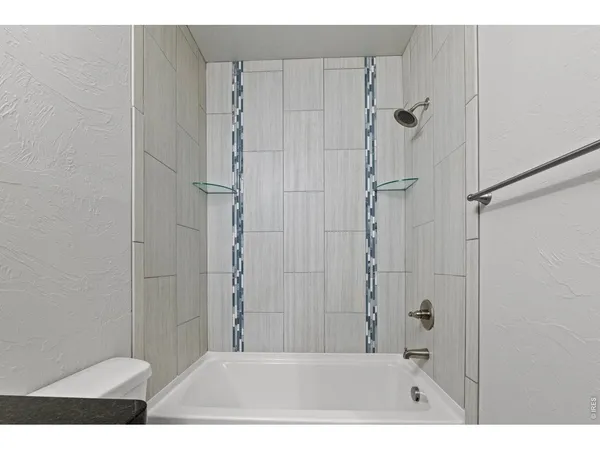 a bathroom with a shower and a toilet