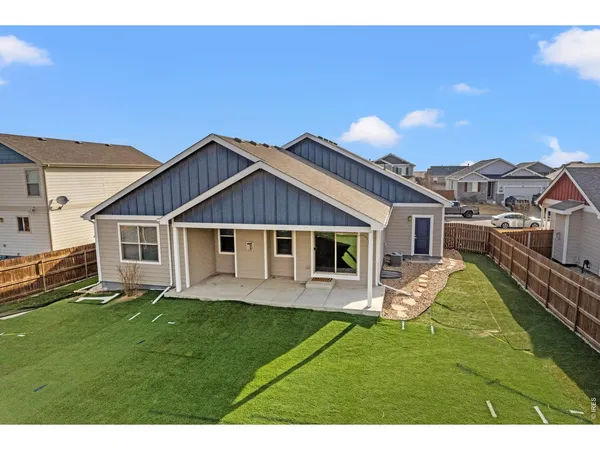 an aerial view of a house with a yard