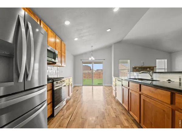a view of a kitchen with a sink and a kitchen island