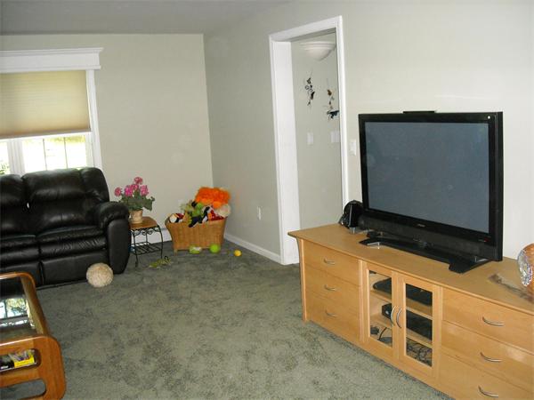 35 Easter Brook Road Lunenburg, MA 01462 - Photo 4 of 27 a living room with a flat screen tv on dresser and a table