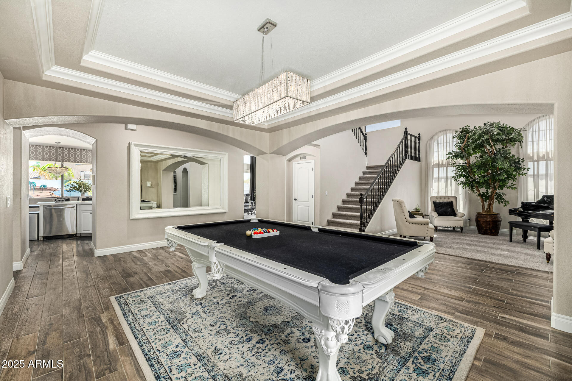 1517 South Arroya Circle Mesa, AZ 85206 - Photo 22 of 111 a view of a livingroom with wooden floor and a chandelier