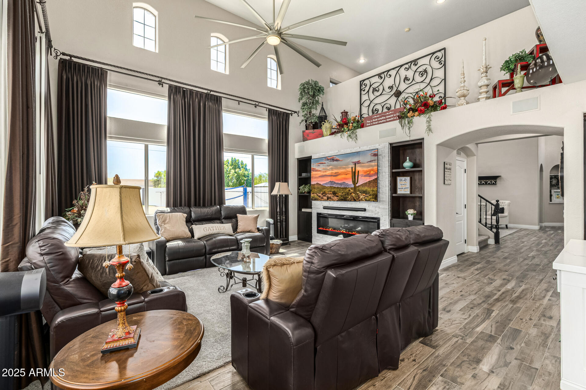 1517 South Arroya Circle Mesa, AZ 85206 - Photo 26 of 111 a living room with furniture a large window and a chandelier