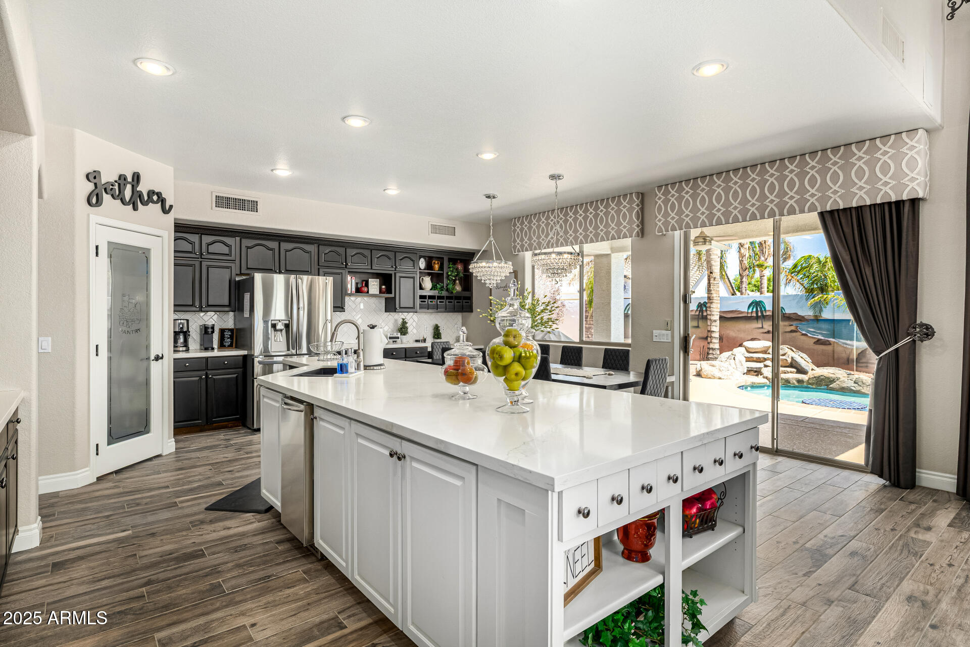1517 South Arroya Circle Mesa, AZ 85206 - Photo 29 of 111 a kitchen with stainless steel appliances granite countertop a refrigerator a sink dishwasher a oven and a dining table with wooden floor