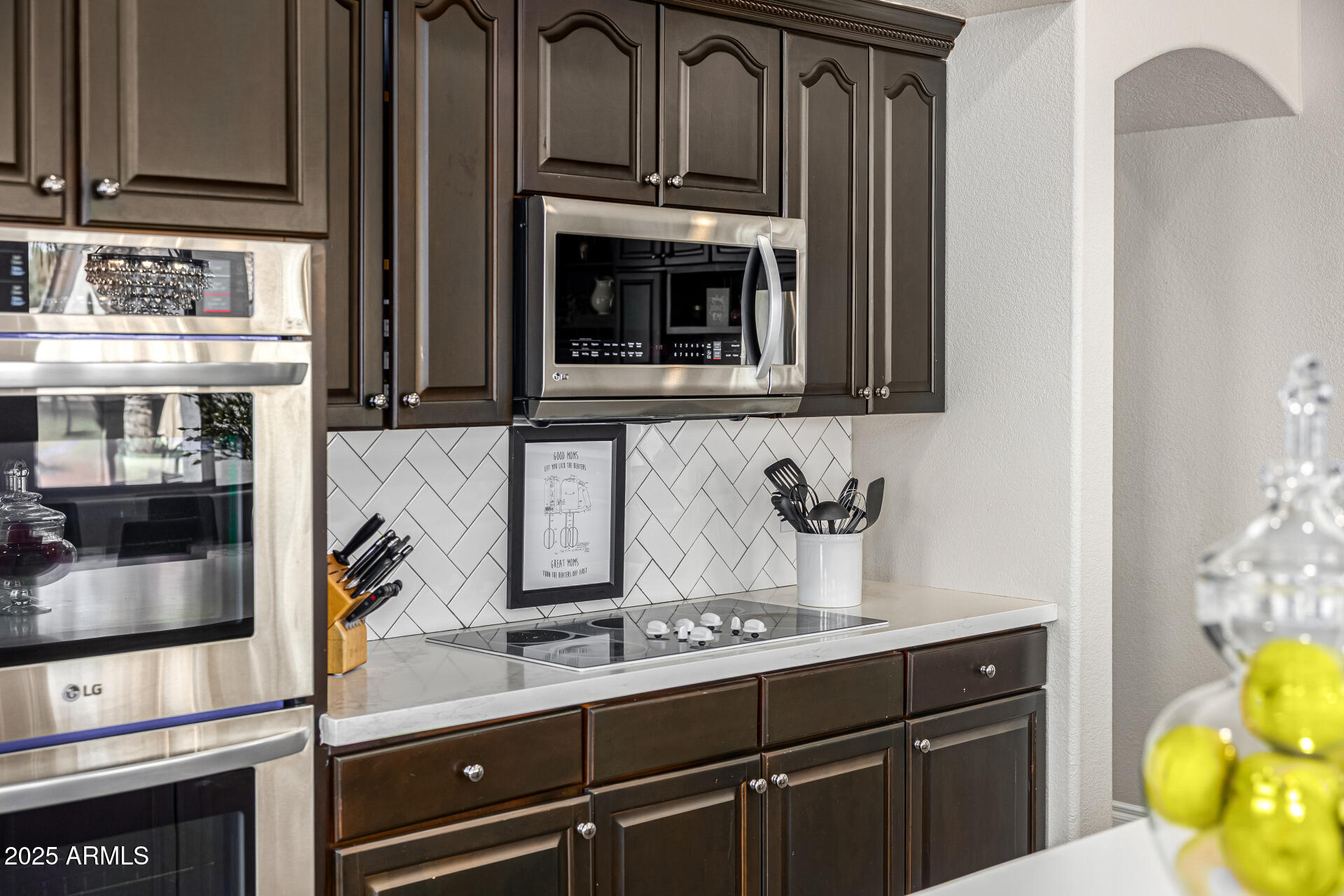 1517 South Arroya Circle Mesa, AZ 85206 - Photo 34 of 111 a kitchen with stainless steel appliances granite countertop a stove and a microwave