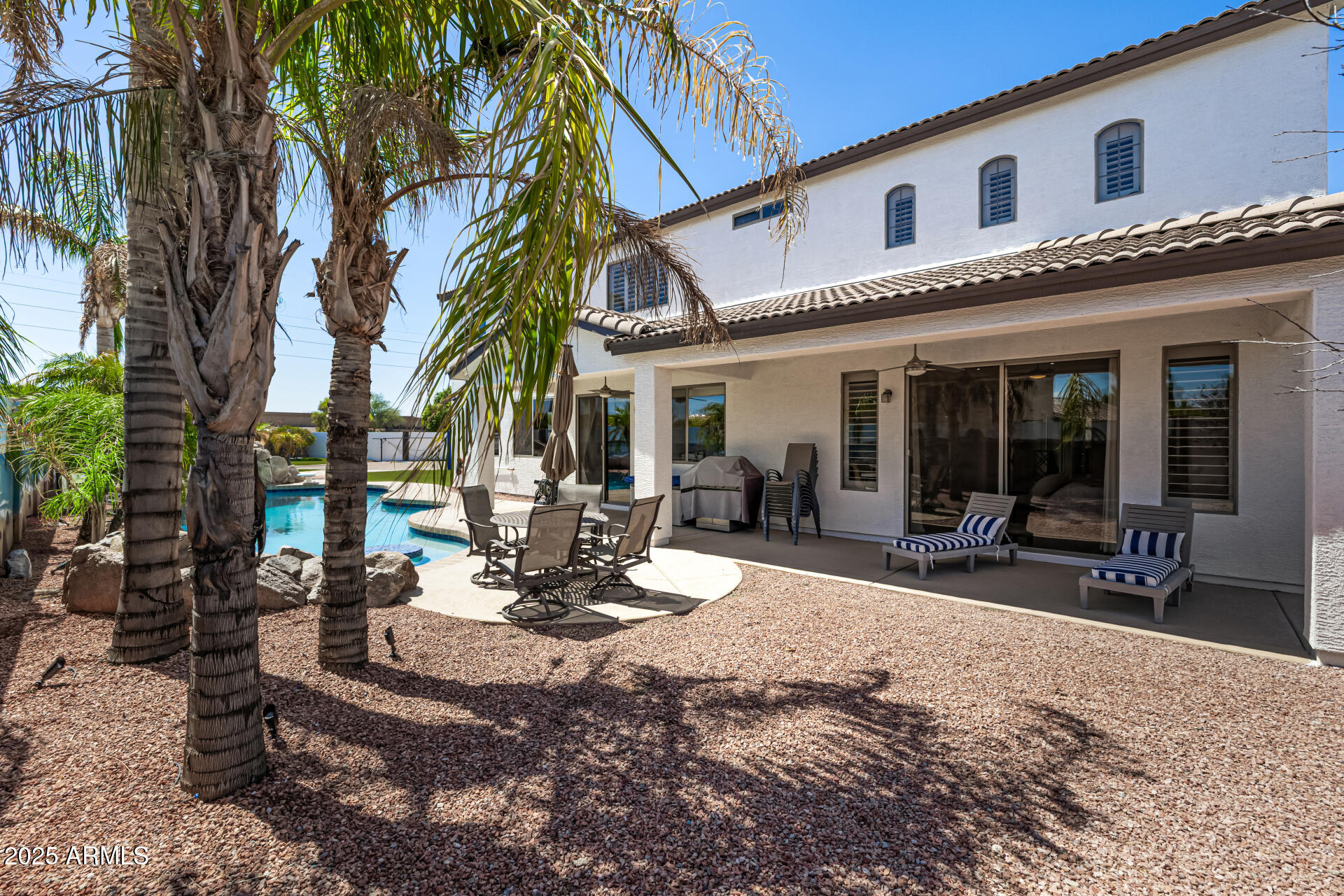 1517 South Arroya Circle Mesa, AZ 85206 - Photo 86 of 111 a view of a patio with table and chairs and floor to ceiling window