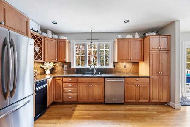 a kitchen with stainless steel appliances granite countertop a refrigerator and a sink